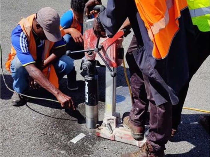 GID field crew operating a coring rig on the runway at Canouan Airport